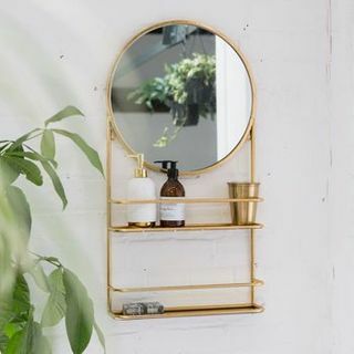 Zlaté alebo strieborné kruhové kúpeľňové zrkadlo s policami