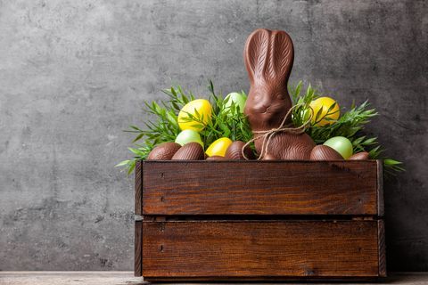 Tradičné veľkonočné čokoládový zajačik a vajcia vo vnútri drevenej prepravky